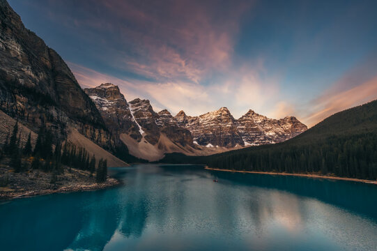 Mountains and Moraine Lake in Banff, Alberta, Canada at sunrise.