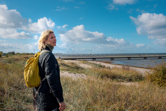 Female Traveler in Malmo, Sweden Looking Out At The Ocean