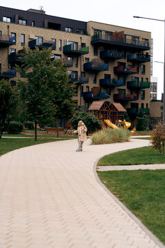 A cheerful girl rides a skateboard in the park