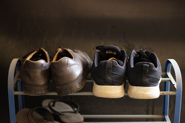 Shoes and Slippers on a Metal Rack