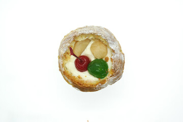 cream puff or choux pastry filled with cherries isolated on white background