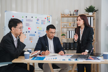 Business Meeting: A diverse team of professionals gathers around a table, discussing important data and charts.  The atmosphere is focused and engaged.