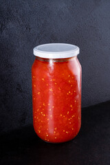 Traditional homemade canned tomatoes. Canned tomatoes prepared for winter meals