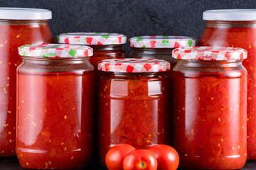 Traditional homemade canned tomatoes. Canned tomatoes prepared for winter meals