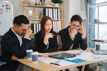 Business Brainstorming:  A diverse team of business professionals engage in an intense brainstorming session, poring over financial data and charts.