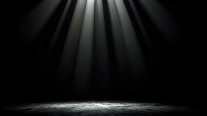 A spotlight shines down on a dark, textured surface, creating a dramatic and mysterious effect.