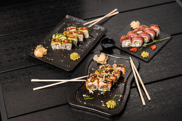 sushi food. Maki ands rolls with tuna, salmon, shrimp, crab and avocado. Top view of assorted sushi. Rainbow sushi roll, uramaki, hosomaki and nigiri.