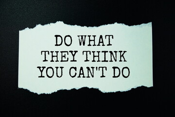 Do what they think you can't do quotes text on paper torn top view on black background,...
