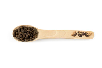 black peppercorns in a wooden spoon on a white background