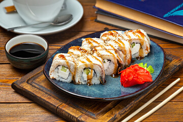 Japanese rolls, sushi with eel on a plate, cafe, restaurant, on a wooden table.