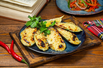 Mussels baked with cheese on a plate, cafe, restaurant, on a wooden table.