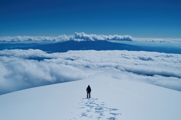A Solitary Hiker Stands Above the Clouds on a Majestic Snowy Peak