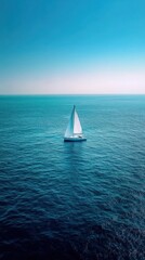 Fototapeta premium Sailing boat floats in endless blue ocean expanse