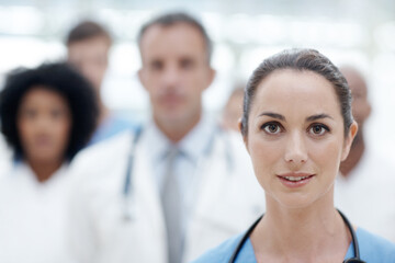 Fototapeta premium Doctor, woman and portrait in hallway at hospital with smile, leadership and career in healthcare. Person, team and happy in corridor at clinic for wellness, services and staff at job in Argentina