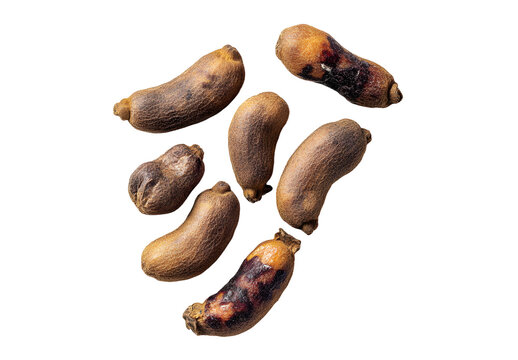 Tamarind tropical fruits isolated on white background. Fresh ripe dryed Tamarind fruits (Tamarindus indica, Indian date), healthy vegan food. Top view, flat lay.