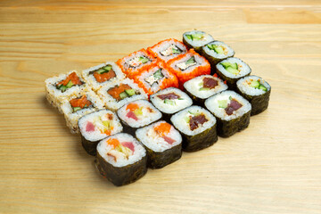 Mix Japanese rolls, sushi on a wooden background.