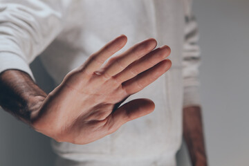 man showing stop sign, hand gesture.