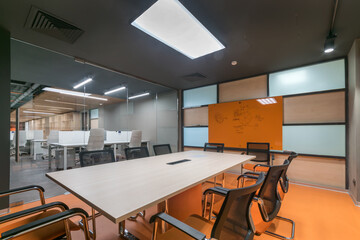 A separate room in a modern office for business meetings and negotiations. A glass .partition opens...
