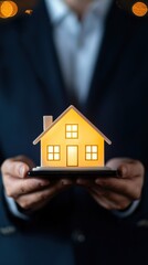 Illuminated Model House in Hands Symbolizing Home Ownership and Real Estate Investment Opportunities