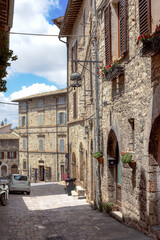 The charming streets of Assisi, a medieval town in Umbria, Italy during a sunny afternoon