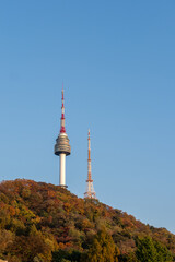 Obraz premium N Seoul Tower with autumn landscape. It is also known as Namsan Tower or Seoul Tower, the landmark which is a communication and observation tower located on Nam Mountain in central Seoul, South Korea