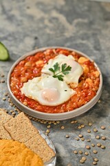 Shakshuka with Poached Eggs and Crackers