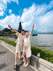 A young Indonesian couple traveling to a Balinese temple
