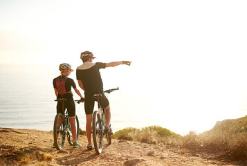 Mountain, bicycle and couple in nature for adventure, workout or training at sunset for marathon....
