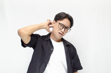 Thoughtful asian man thinking and wondering with hand touching skin as thinking gesture isolated...