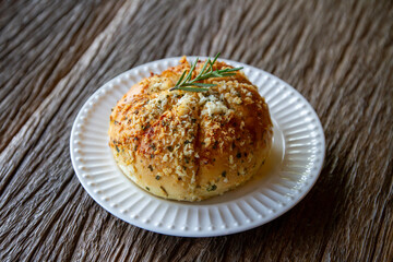 appetizer. Garlic bread on white ceramic plate on wooden top table