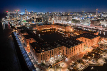 Liverpool waterfront and Albert Dock at night. Aerial view of Liverpool's Albert Dock and city...