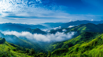 Fototapeta premium Beautiful panoramic view of green mountains and blue sky in the countryside.