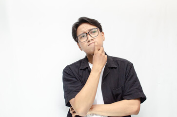 Thoughtful asian man thinking and wondering with hand touching skin as thinking gesture isolated...
