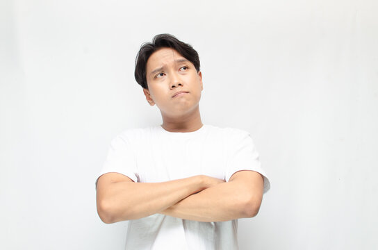 Thoughtful asian man thinking and wondering with hand touching skin as thinking gesture. Thoughtful confused asian man thinking and wondering to choose something. man feeling uncertain and unsure.	
