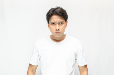 Angry face of young Asian man threatening to cut throat and looking for fight.