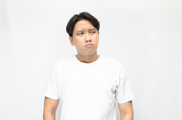 Thoughtful asian man thinking and wondering with hand touching skin as thinking gesture. Thoughtful confused asian man thinking and wondering to choose something. man feeling uncertain and unsure.	