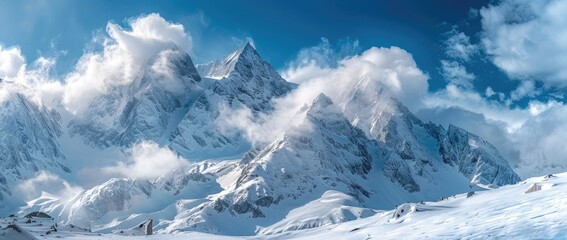 Obraz premium Panoramic view of snow-covered mountains in the Alps, a snow mountain landscape panorama with a blue sky and white clouds