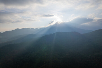 Naklejka premium Aerial view of amazing mountain landscape colorful sunset over the cloudy sky.