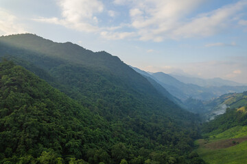 Naklejka premium Aerial view of amazing mountain landscape colorful sunset over the cloudy sky.