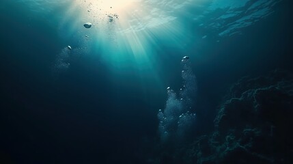 Fototapeta premium A serene underwater view featuring dark blue ocean water with soft light rays filtering through, bubbles rising towards the surface, and a mysterious deep-sea atmosphere. This immersive scene captures