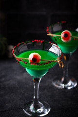 Spooky green Halloween cocktail with eyeball