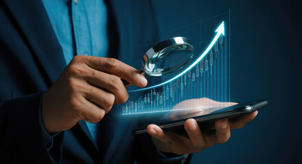 Businessman holding a magnifying glass analyze upward trend stock chart with smartphone.
