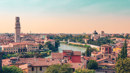 Fototapeta premium panoramic view of Italian cityscape with river at sunset. Travel destination, tour tourism, romantic weekend concept
