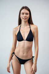 Summer, body and portrait of woman in studio with confidence for fashion and swimwear. Model girl, happiness and bikini for tropical holiday and relax with aesthetics and glow by white background