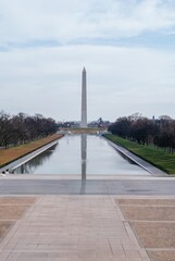 Fototapeta premium The Washington Monument is in the background of a large, empty pool