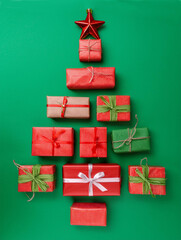 Colorful Christmas tree made of wrapped gifts arranged on a vibrant green background for festive decoration