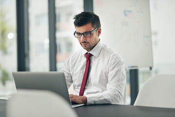 Man, glasses and laptop in office for business, finance planning and productivity at table. Accountant, specs and typing on computer for research, email communication and connectivity in workplace