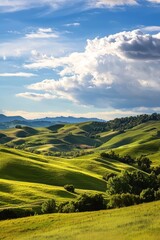 Fototapeta premium Vibrant green rolling hills under a dramatic sky, creating a serene and picturesque landscape.