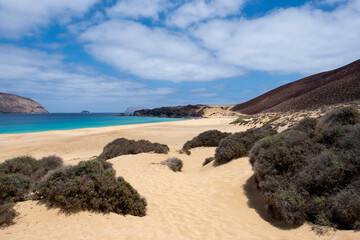 The Conchas beach on the island of La Graciosa in Lanzarote, Canary Islands, Spain, a deserted virgin beach with fine sand, dunes and turquoise blue water