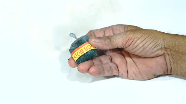 Diwali Fire Bomb Cracker lit on Hand,  Lit fuse bomb on hand | Diwali Background